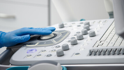 Close-up of ultrasound equipment with a probe in a modern diagnostic center. The concept of precision and advanced technology in professional medicine.