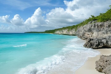Fototapeta premium Stunning Turquoise Water Beach Scene with White Sand and Rocky Cliffs under a Blue Sky with Fluffy White Clouds