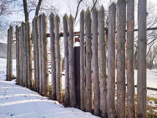 Fence made of old weathered logs Antique wooden fence