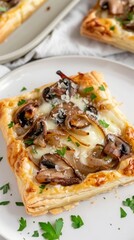 Mushroom tart with caramelized onion and parmesan served on a white plate