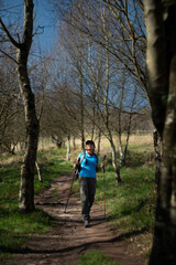 Fototapeta premium A hiker looks at the trees in her path.