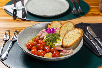 Salad with cherry tomatoes, bread, white cheese and ham
