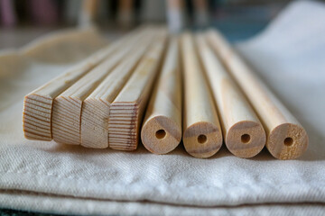 Wooden bars of different cross-sections, rectangular and round, end view of section. Natural color of wood, close-up