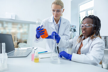 Two people working with the vacutainers in a school laboratory