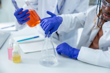 Fototapeta premium Two people working with the vacutainers in a school laboratory