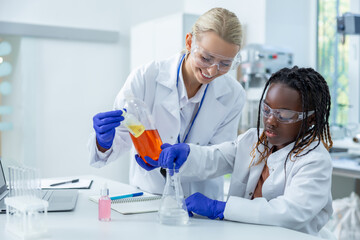 Two people working with the vacutainers in a school laboratory