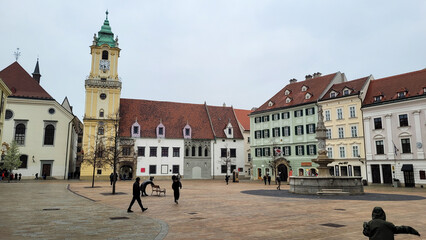 Obraz premium Scenic European Square with Historic Buildings and Clock Tower