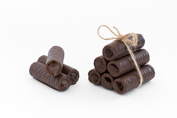 Sweet chocolate covered rolls - table arrangement, isolated on white background. Selective focus. Copy space.