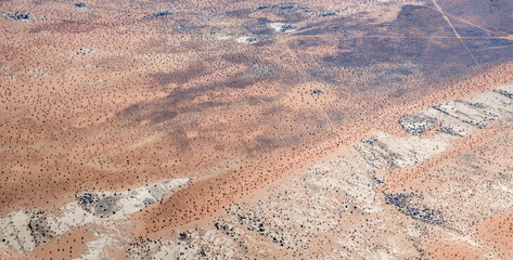 gray and red sand dunes in Kalahari desert countryside, near Cowdray farm, Namibia