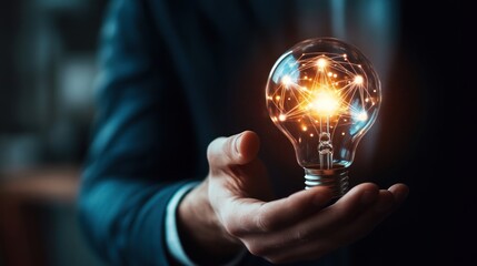 Man holds glowing light bulb. Concept of innovation, idea. Dark background. Use for business