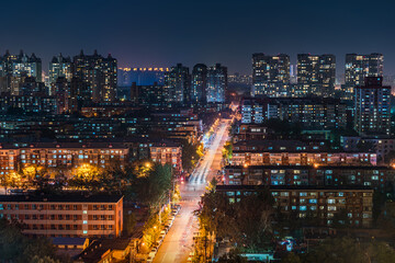 The brightly lit streets under the night view of Beijing city