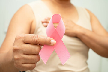 Asian woman with pink ribbon for October world breast cancer day.