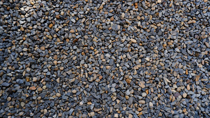 Pebble texture or pebble background for home accent. Original grunge texture background and small stones. Top view of gravel driveway on the ground