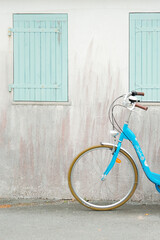Blue bicycle in front of a house