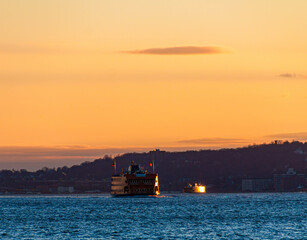 Fototapeta premium The Staten Island Ferry Crosses New York Harbor From Battery Park, New York, New York, USA