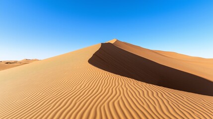 A vast desert landscape with only one smooth sand dune and a single shadow