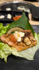 Eating Korean-style grilled meat consisting of meat and vegetables.