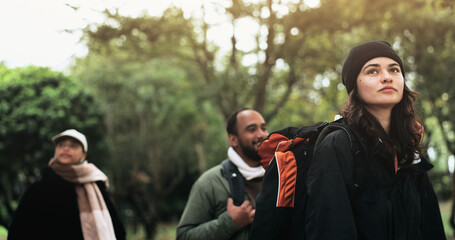 Friends, walking and hiking adventure in nature together, man and women in forest for outdoor travel. Trekking, backpack and group of people on camping trip with trees, freedom and vacation in woods