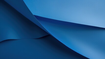 Obraz premium A smooth metallic surface with a glossy gradient finish is placed on a Pacific deep blue paper background, showing a modern and sleek aesthetic. The deep blue hue of the paper contrasts beautifully 