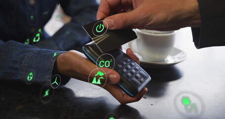 Image of network of eco icons over caucasian man paying with card