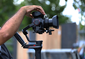 
Cameraman adjusting professional camera with stabilizer
