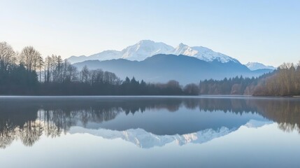 Fototapeta premium Lake Reflecting Snow-capped Mountains and Forest on a Calm Morning