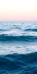 Obraz premium A serene ocean view with gentle waves and a soft blue gradient, perfect for a calming mobile wallpaper backdrop. 