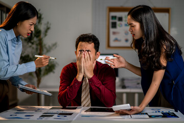 Three people are arguing in a room with a desk in the middle