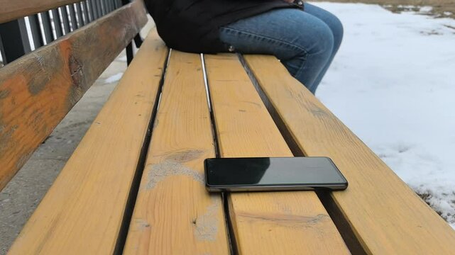 theft. natural light. forgotten phone on a street bench. . close-up 4K