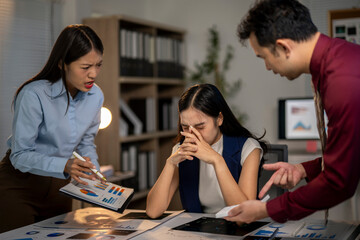 Three people are in a room, one of them is crying
