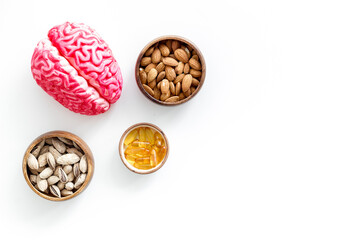 Healthy food for the brain. Human brain model with nuts and grain, top view