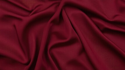 Fototapeta premium Deep crimson red fabric background with smooth and elegant waves