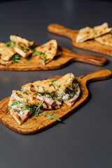 Pizza-Sandwich with Mortadella and Roasted Eggplant – vertical composition with Pizza Sandwiches Served on Wooden Platters in a Rustic Setting