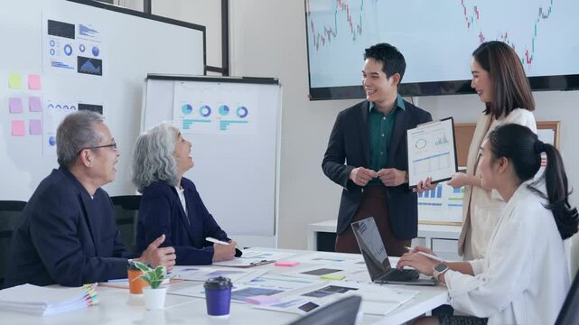 Professional team analyzing market trends, charts, and graphs during collaborative meeting, showcasing strategic decision making in modern corporate environment