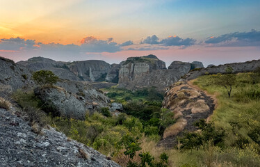 Breathtaking sunset over the Pedras Negras Mountains in Angola showcasing rugged terrain and lush valleys