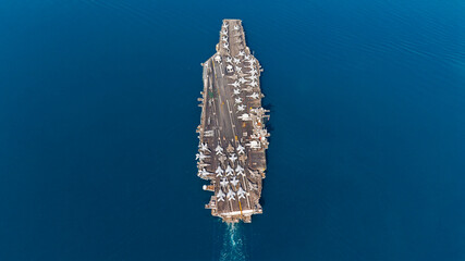 Aerial view military navy ship carrier at blue sea.