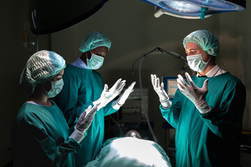 Professional males and female medical team concentrating perform critical surgical operations in...