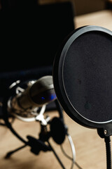 On the air concept - microphone with filter and laptop computer. Podcast recording