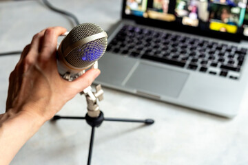 Home studio for podcast recording. Microphone and laptop on table