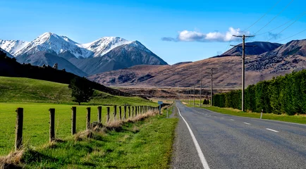 Selbstklebende Fototapeten beautifui road and green grassland with snow mountains nature landscape in New Zealand. Road trip.. © yuzu25