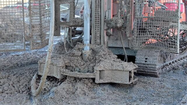 Close-up of Construction process of drilling and pouring concrete at a construction site 