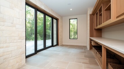 Obraz premium Modern Interior with View: A spacious, contemporary interior with a seamless transition to the outside through large glass doors that open to lush greenery.