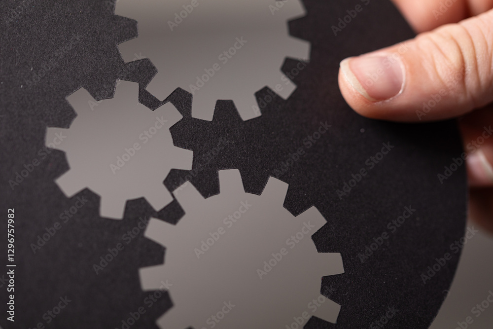 Poster abstract image of three interconnected gears, symbolizing teamwork, mechanism, and collaboration.