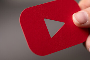Close-up of a red YouTube play button.  Perfect for video, social media, and technology concepts.