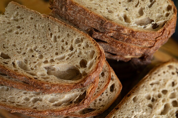 Close-up of rustic sourdough bread slices, perfect for baking blogs and food websites.