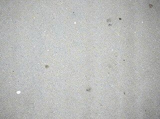 Texture of a grainy, mottled, light gray concrete or cement surface with subtle variations in tone.