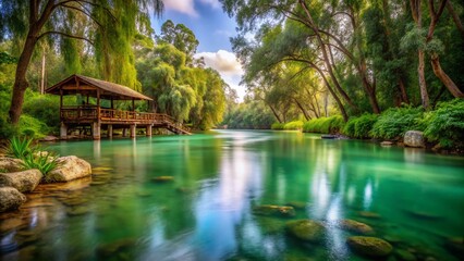 Serene Jordan River: Calm Waters, Lush Banks, Wooden Structure, Overcast Sky - Stock Photo