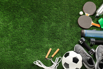 Different sports equipment on artificial grass, flat lay. Space for text
