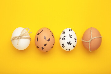 Easter background - white easter egg with flowers inside on yellow background. Happy easter, spring, summer floral concept