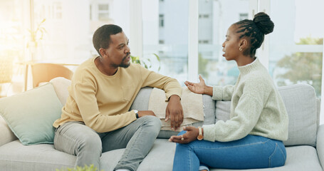 Black couple, conflict and fight on sofa in home living room for questions, anger or mistake in...